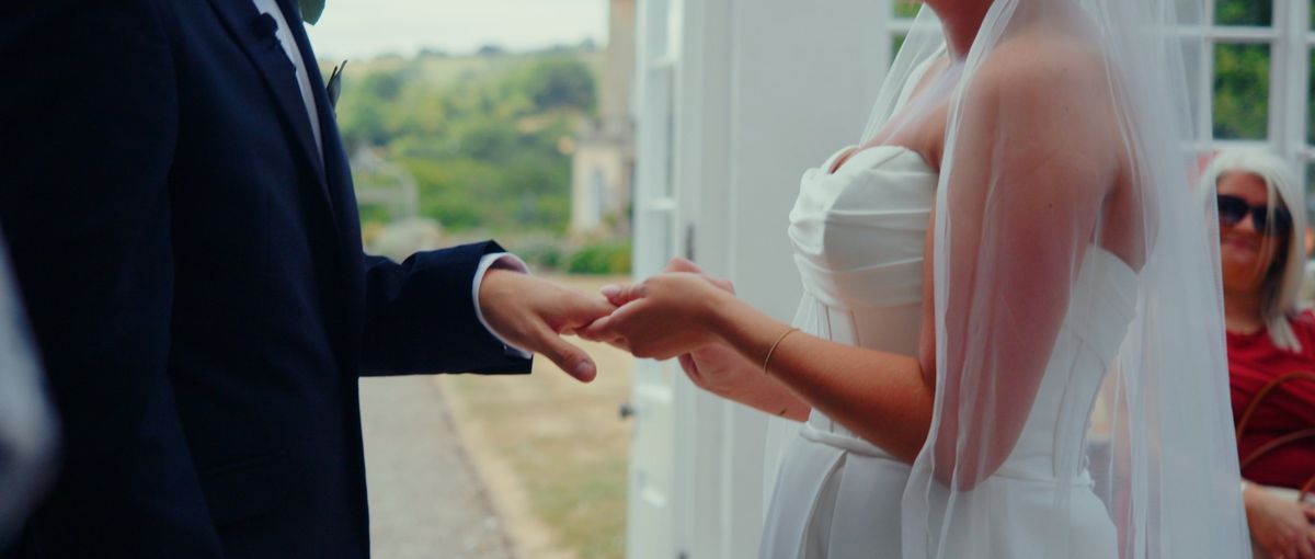 Hands exchanging rings during the ceremony
